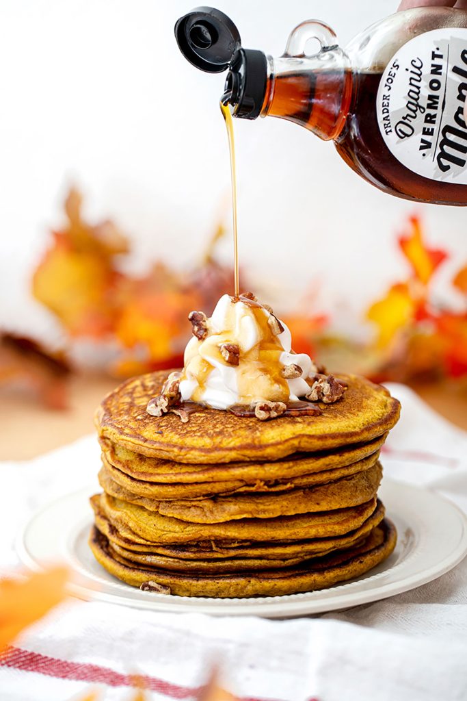 pumpkin pancakes pouring maple syrup